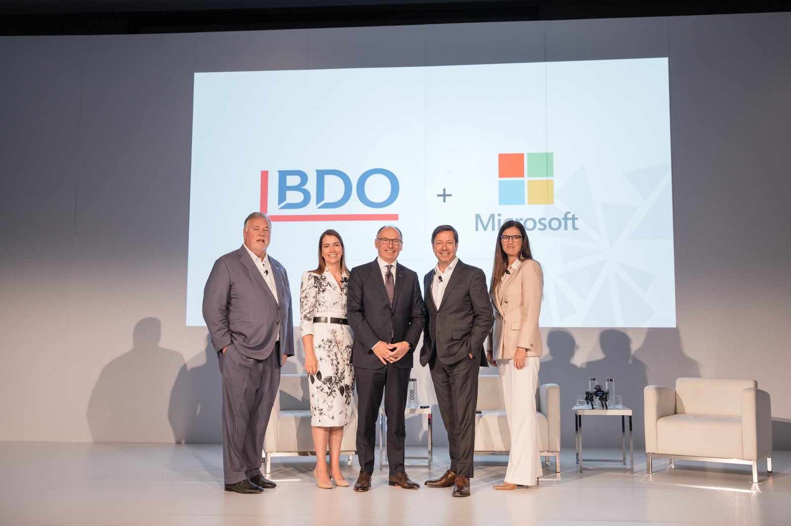 Panel on stage in front of the BDO and Microsoft partnership screen